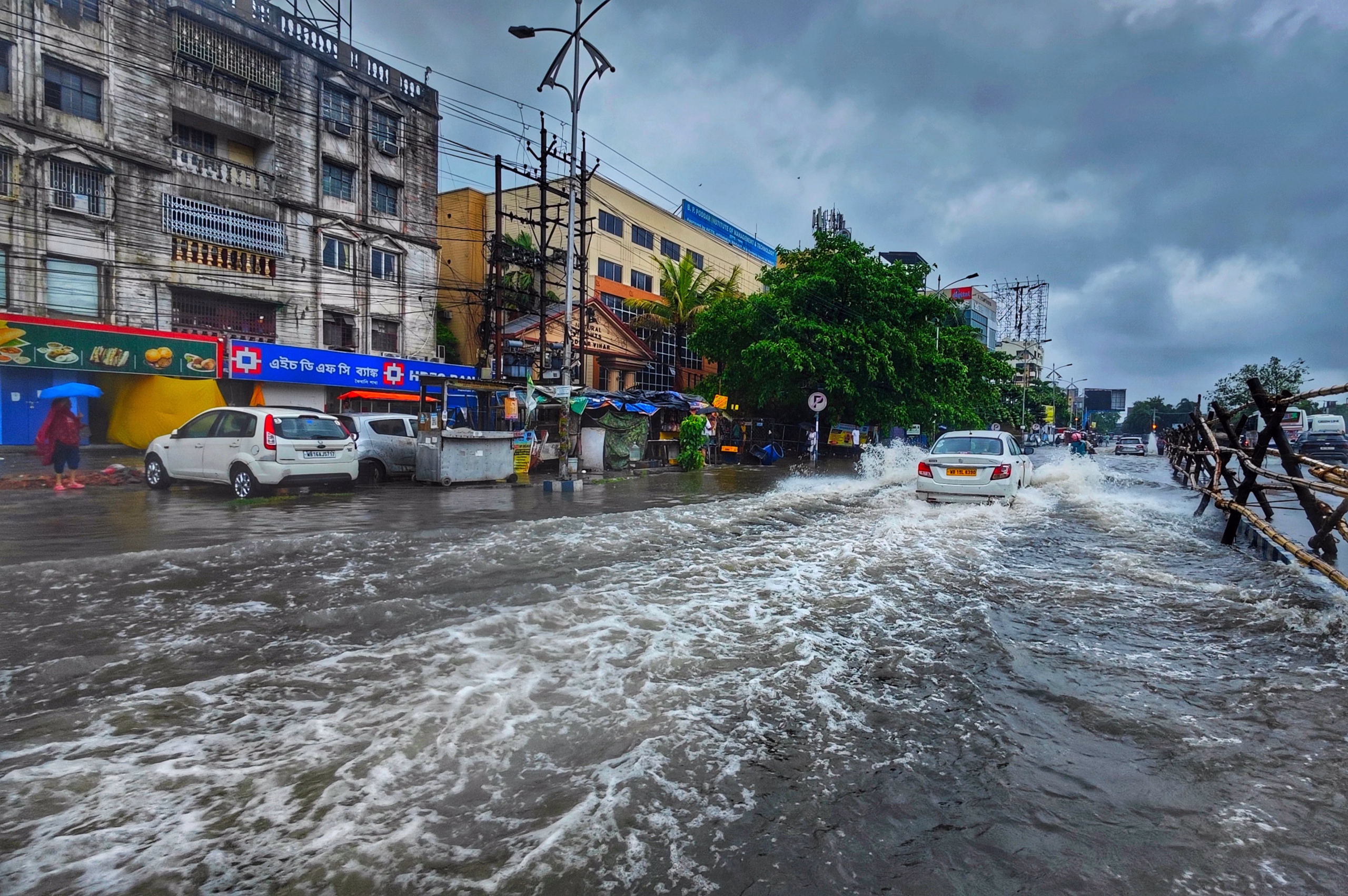 Super El Niño 2026 urban flooding on a city street with vehicles driving through heavy floodwater
